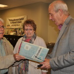 Touring The Front Door, they stop to show Unity House CEO, their St. Columbus yearbook featuring Mary Jane Smith.