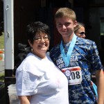 Martha Lasher-Warner congratulates a runner in The Run for Help