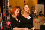 Maggie Watson, left, shares a laugh with Kelley from Collar City Sweets.