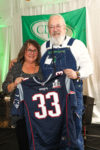 Linda Lewis, proud mom to Dion Lewis of the NE Patriots proudly presents Dr. Paul Byron with his winning Superbowl Jersey, which will be signed by Dion Lewis.