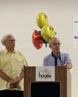 John Baackes, in yellow, with Regis Obijiski, speaking